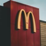 Close-up of McDonald's logo featuring a maple leaf on a building in Surrey, BC, Canada.